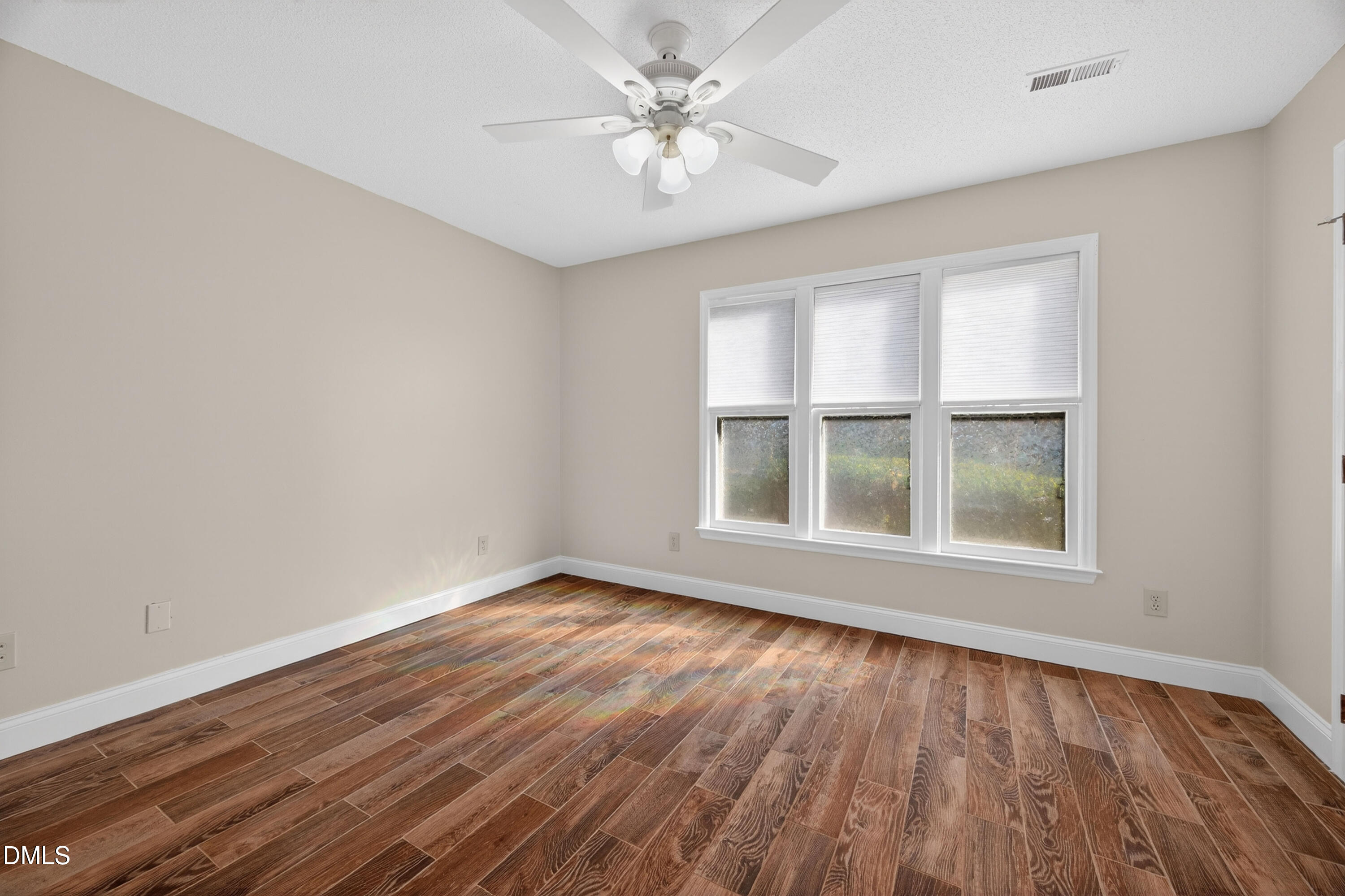 109 Linville River Road Cary, NC 27511 - Photo 28 of 41 an empty room with wooden floor and windows