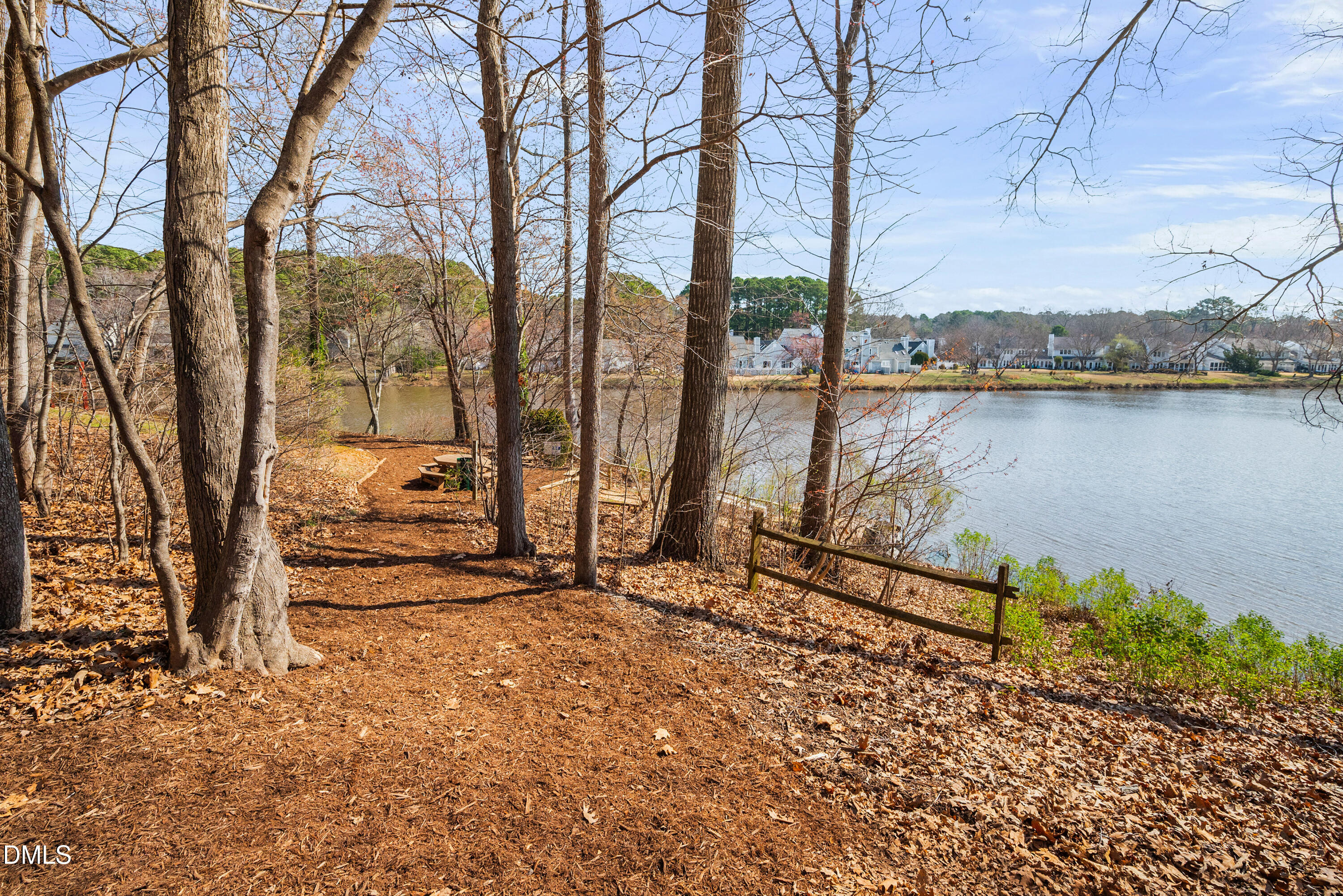 109 Linville River Road Cary, NC 27511 - Photo 37 of 41 a view of a bench next to a lake