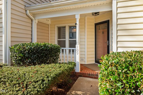 a view of a street with cars parked in front of house