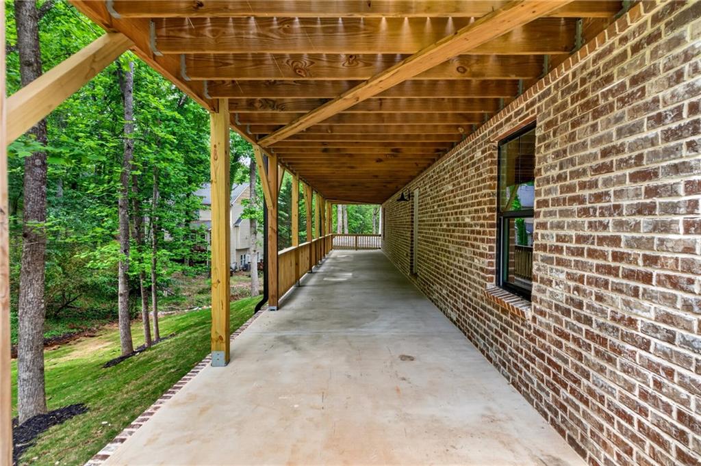 4299 Forest Place Cumming, GA 30041 - Photo 44 of 54 a view of a pathway of a house with wooden floor and roof
