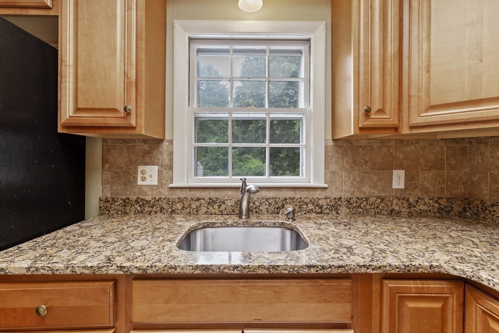 254 Edgell Road Framingham, MA 01701 - Photo 11 of 42 a kitchen with granite countertop cabinets sink and window