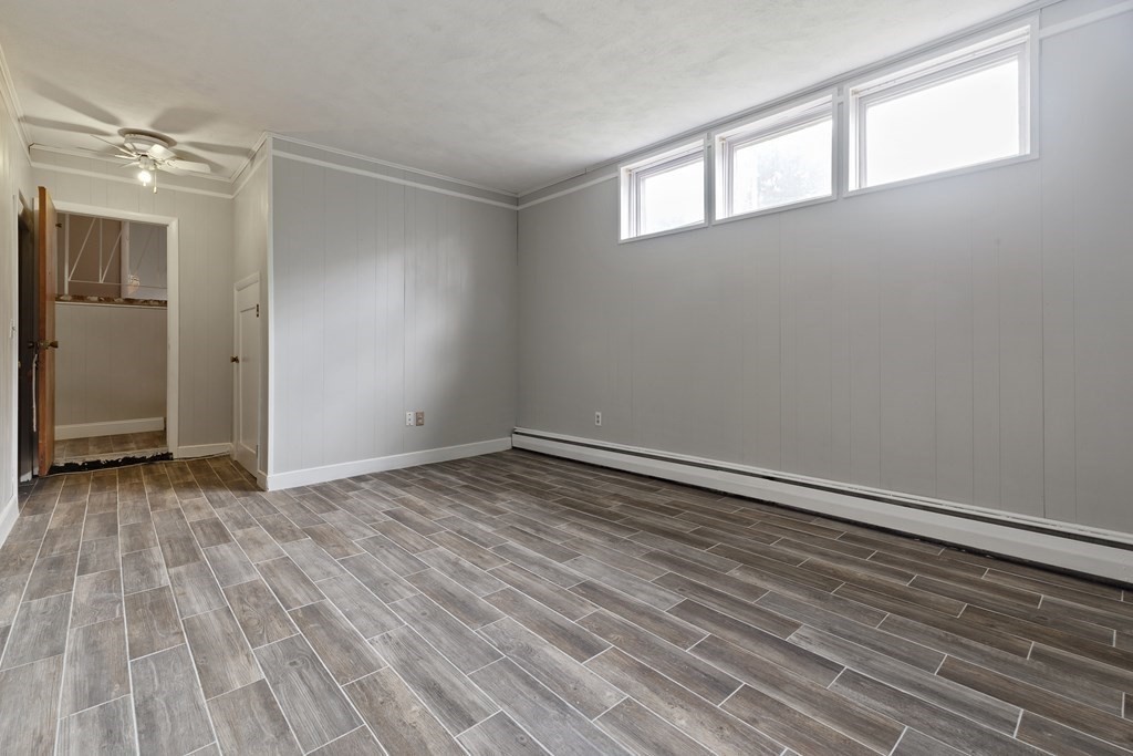 254 Edgell Road Framingham, MA 01701 - Photo 13 of 42 a view of an empty room with wooden floor and a window