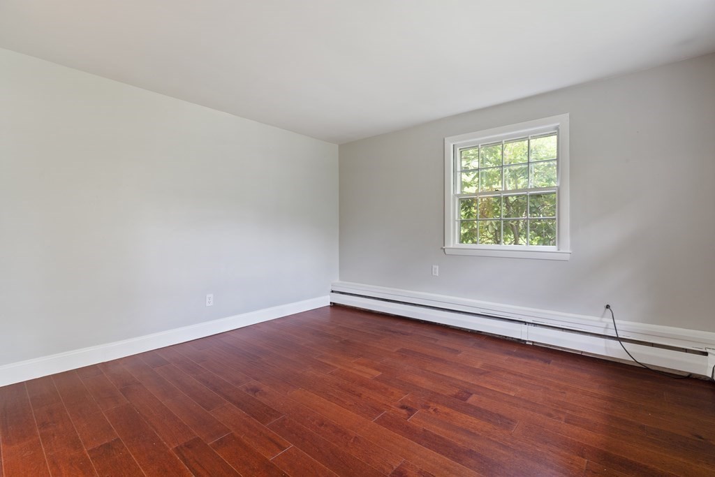 254 Edgell Road Framingham, MA 01701 - Photo 17 of 42 an empty room with wooden floor and windows