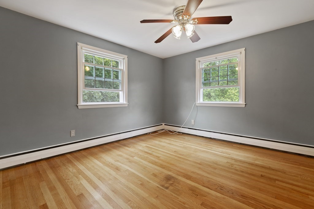 254 Edgell Road Framingham, MA 01701 - Photo 18 of 42 a view of an empty room with wooden floor and a window