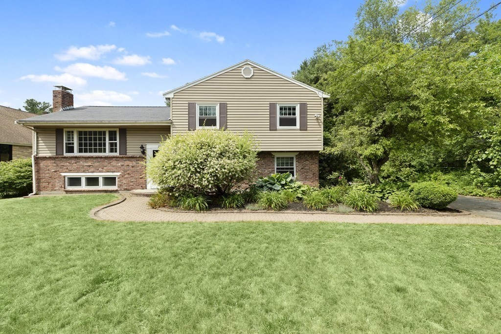 254 Edgell Road Framingham, MA 01701 - Photo 2 of 42 a front view of a house with a yard and trees