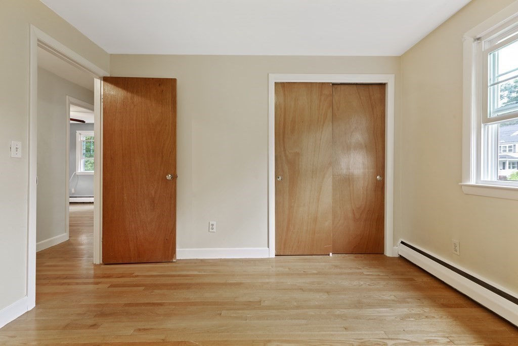 254 Edgell Road Framingham, MA 01701 - Photo 22 of 42 a view of an empty room with window and wooden floor