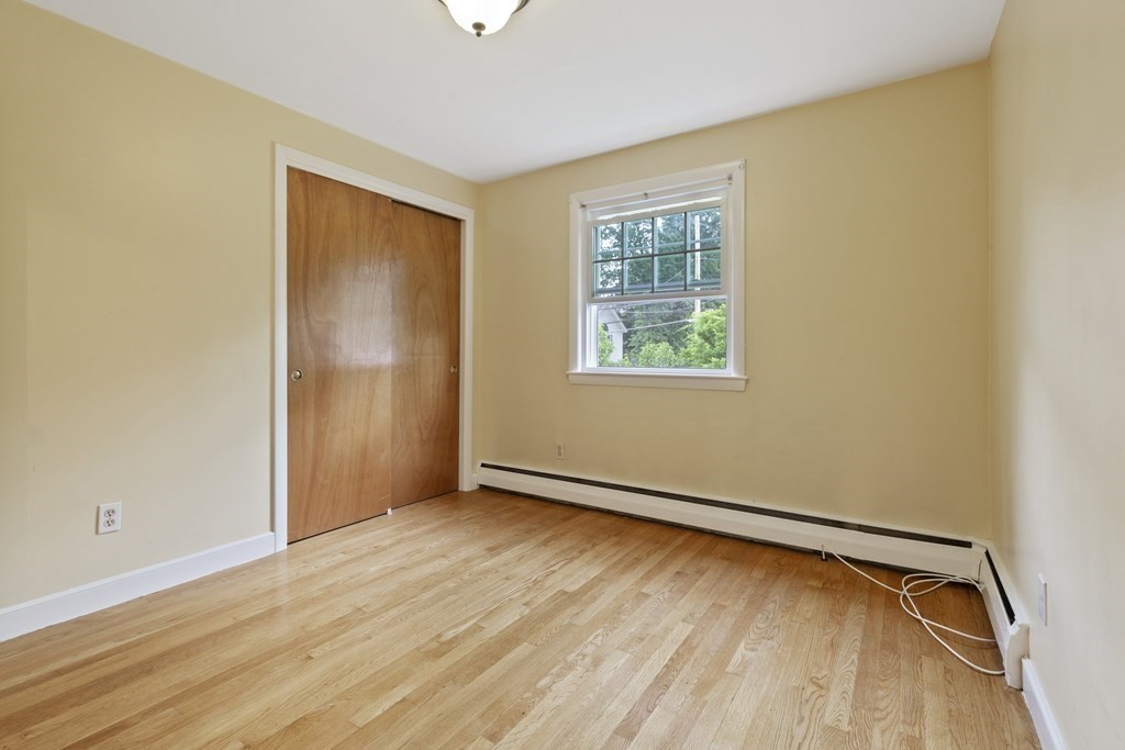 254 Edgell Road Framingham, MA 01701 - Photo 23 of 42 an empty room with wooden floor and windows