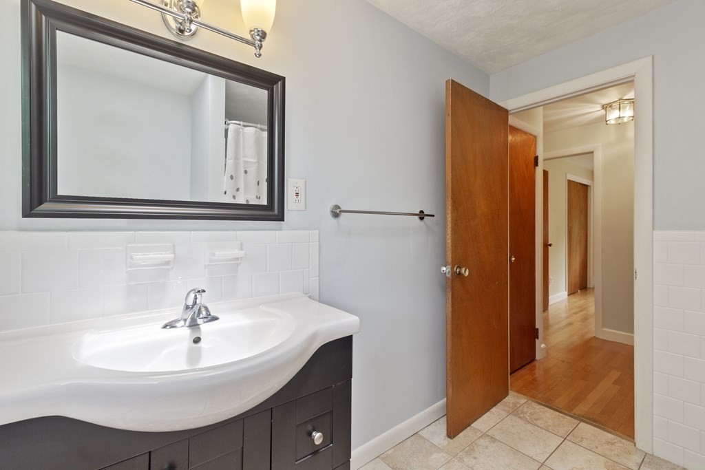 254 Edgell Road Framingham, MA 01701 - Photo 25 of 42 a bathroom with a sink a mirror and a shower