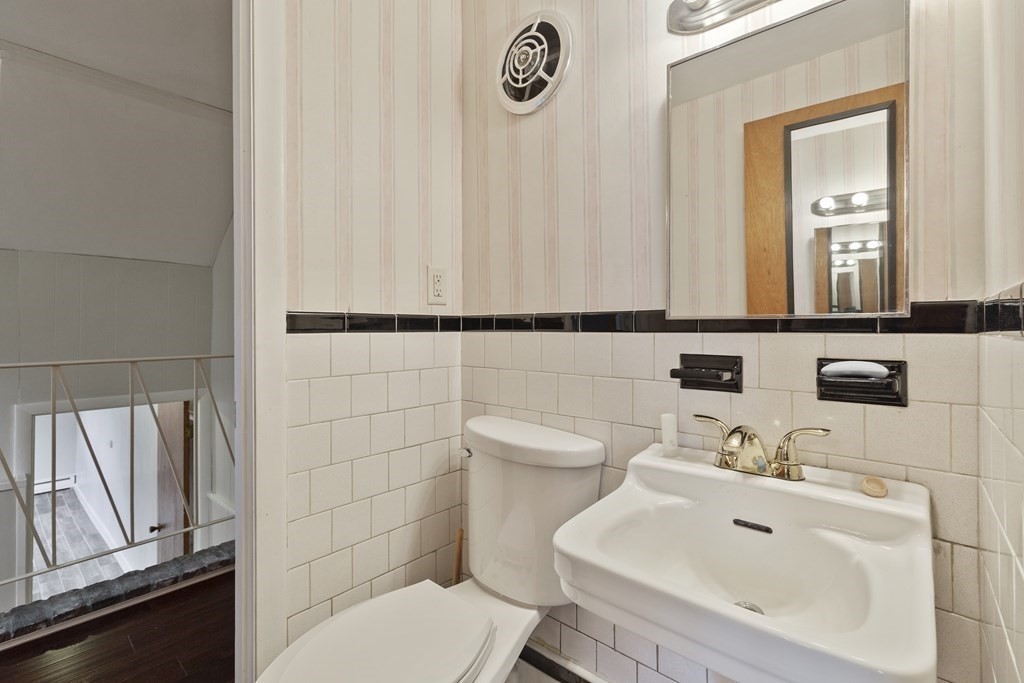 254 Edgell Road Framingham, MA 01701 - Photo 26 of 42 a bathroom with a sink a toilet and mirror