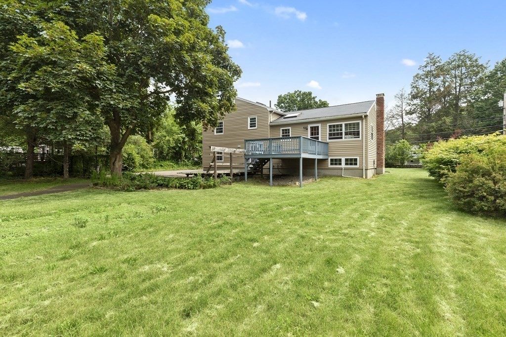254 Edgell Road Framingham, MA 01701 - Photo 31 of 42 a view of a house with a big yard potted plants and large tree