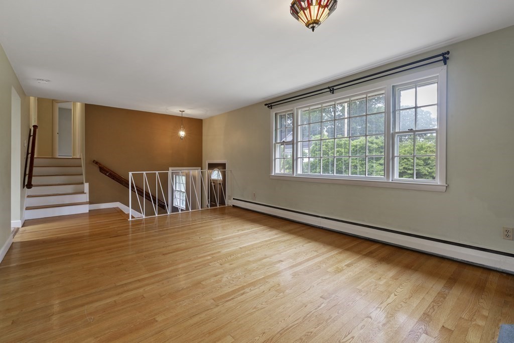 254 Edgell Road Framingham, MA 01701 - Photo 5 of 42 a view of an empty room with wooden floor and a window