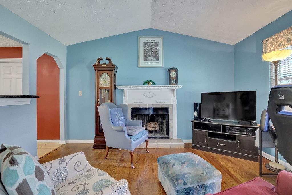 1555 Rock Springs Road Buford, GA 30519 - Photo 14 of 27 a living room with furniture a flat screen tv and a fireplace