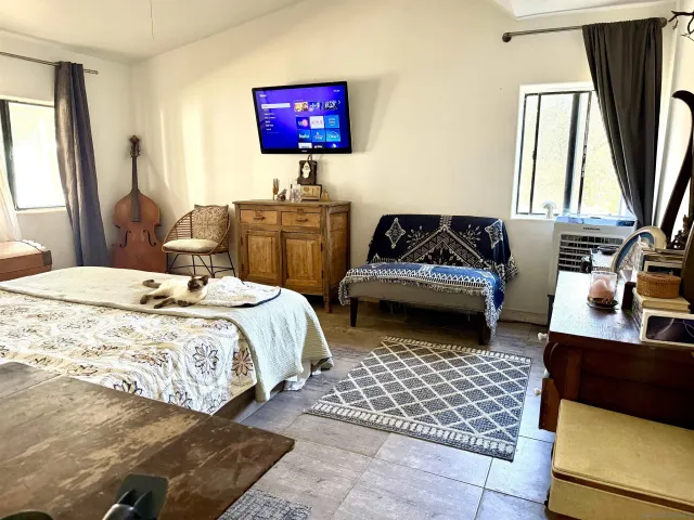 a bedroom with a bed and a couch