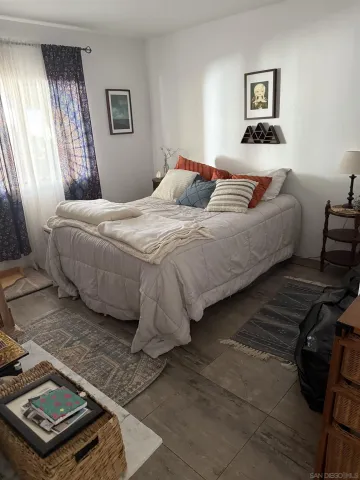 a bedroom with bed and window