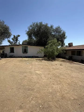 a backyard of a house with outdoor seating