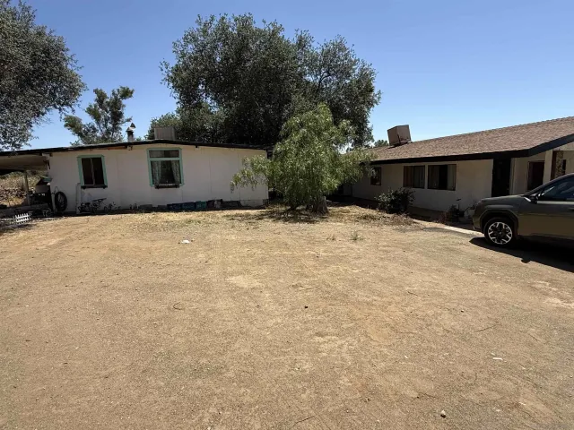 a bedroom with a bed and teddy bear on bed
