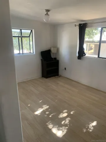 a bed sitting in a room next to a window