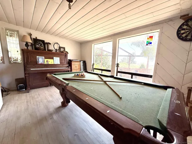 a living room with a table chairs and a refrigerator