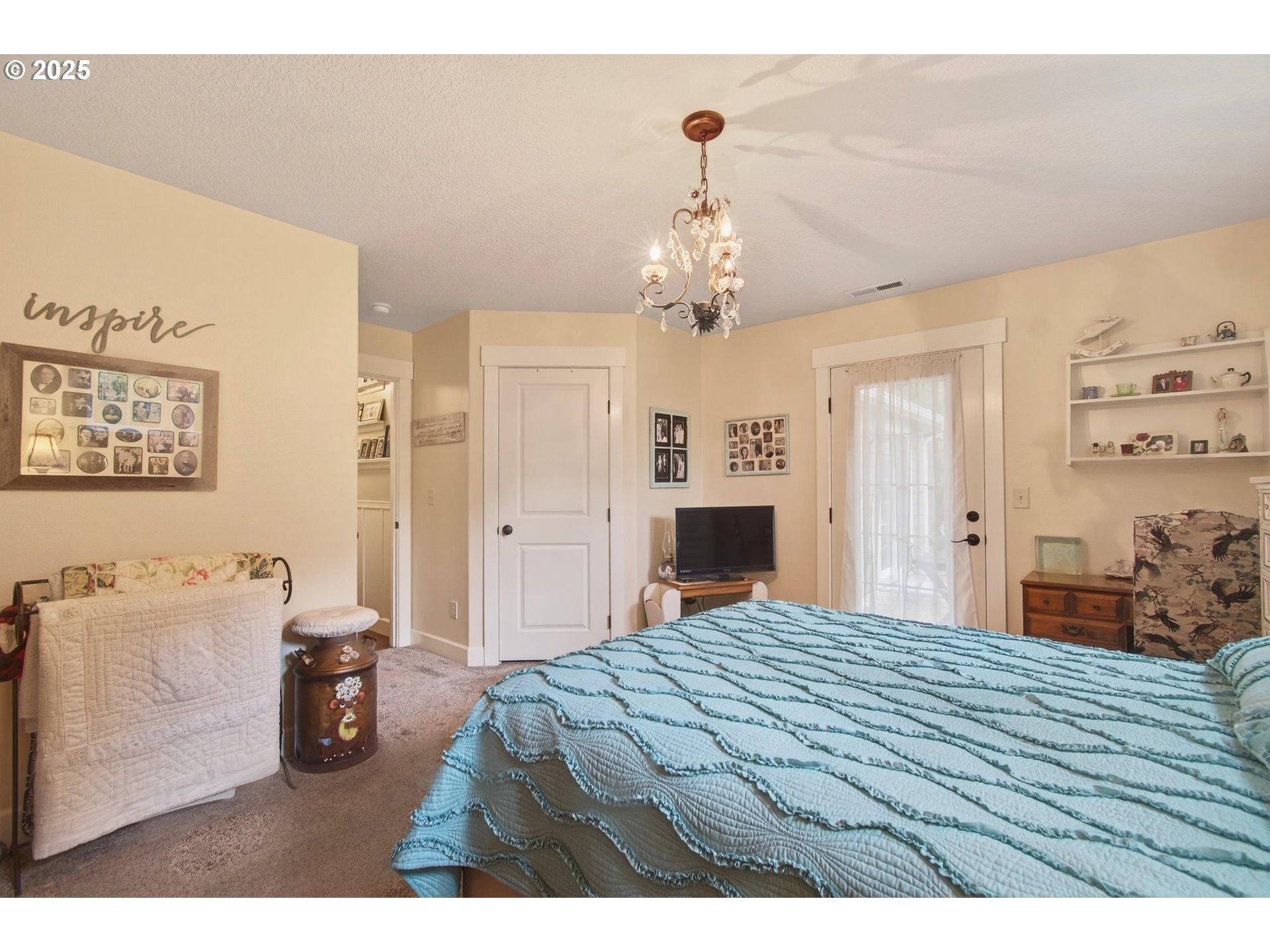 721 Abernathy Creek Road Longview, WA 98632 - Photo 27 of 40 a bedroom with a bed and a chandelier