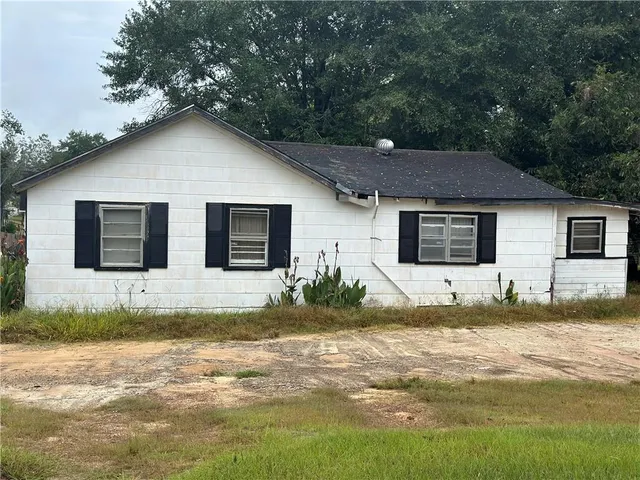 a view of a house with pool and yard