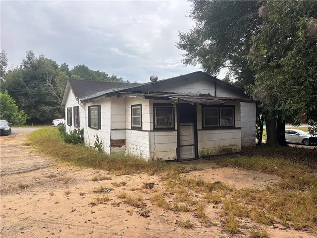 a house with trees in the background