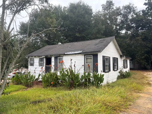 a front view of a house with garden