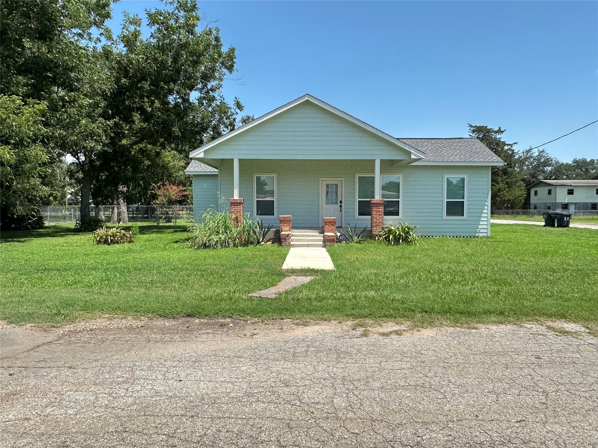 a front view of house with yard and green space