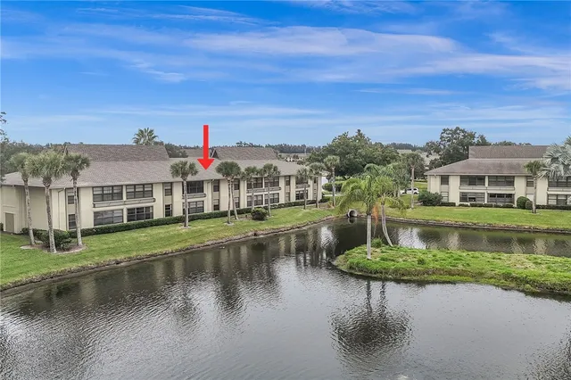 an aerial view of a house with lake view