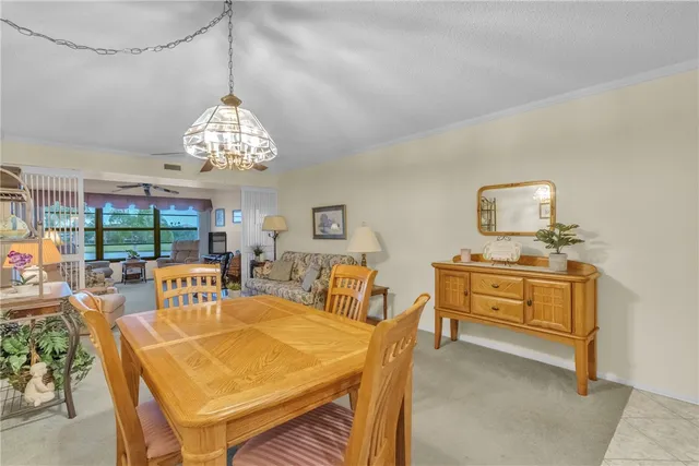 a view of a dining room with furniture wooden floor and chandelier