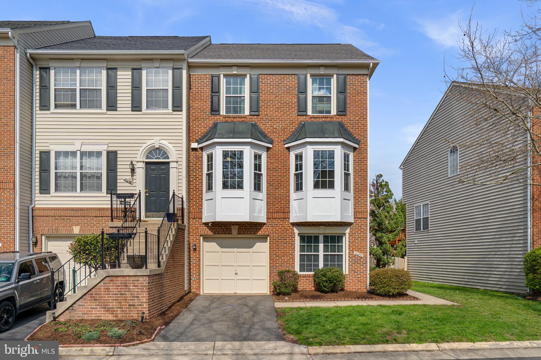 20250 Brookview Square Ashburn, VA 20147 - Photo 1 of 45 a front view of a house with garden