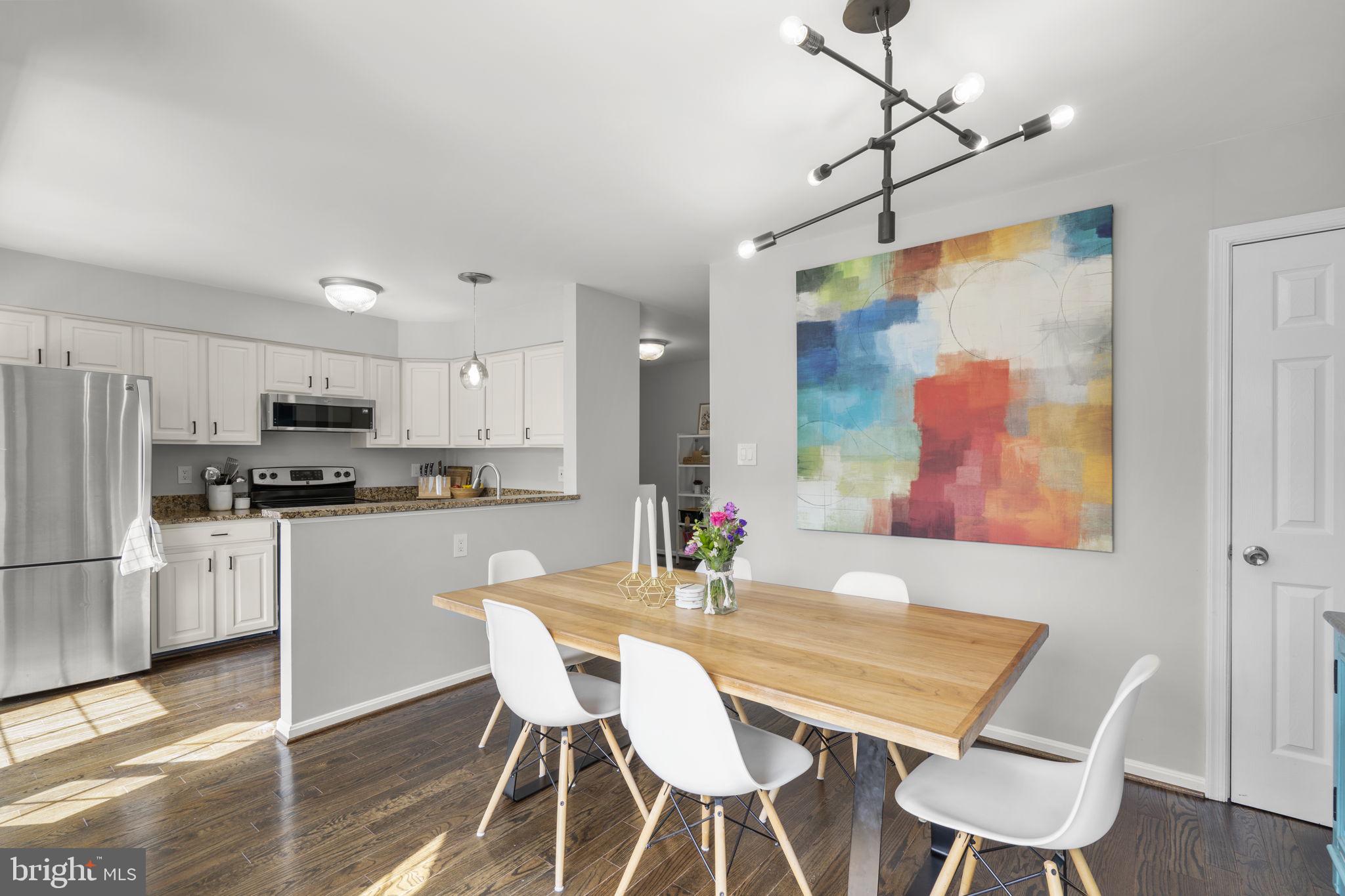 20250 Brookview Square Ashburn, VA 20147 - Photo 13 of 45 a view of a dining room with furniture and wooden floor