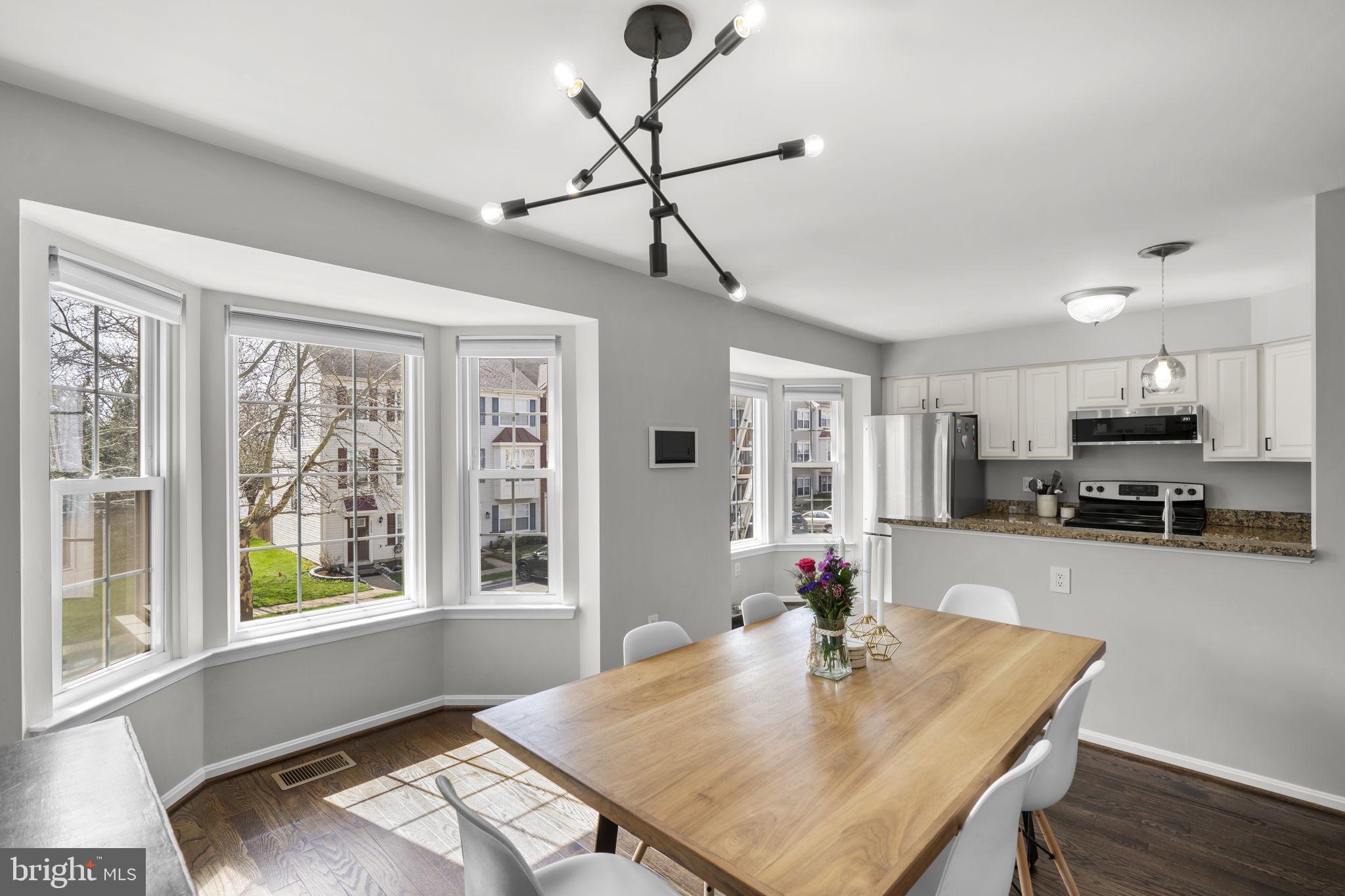 20250 Brookview Square Ashburn, VA 20147 - Photo 14 of 45 a view of a dining room with furniture window and wooden floor