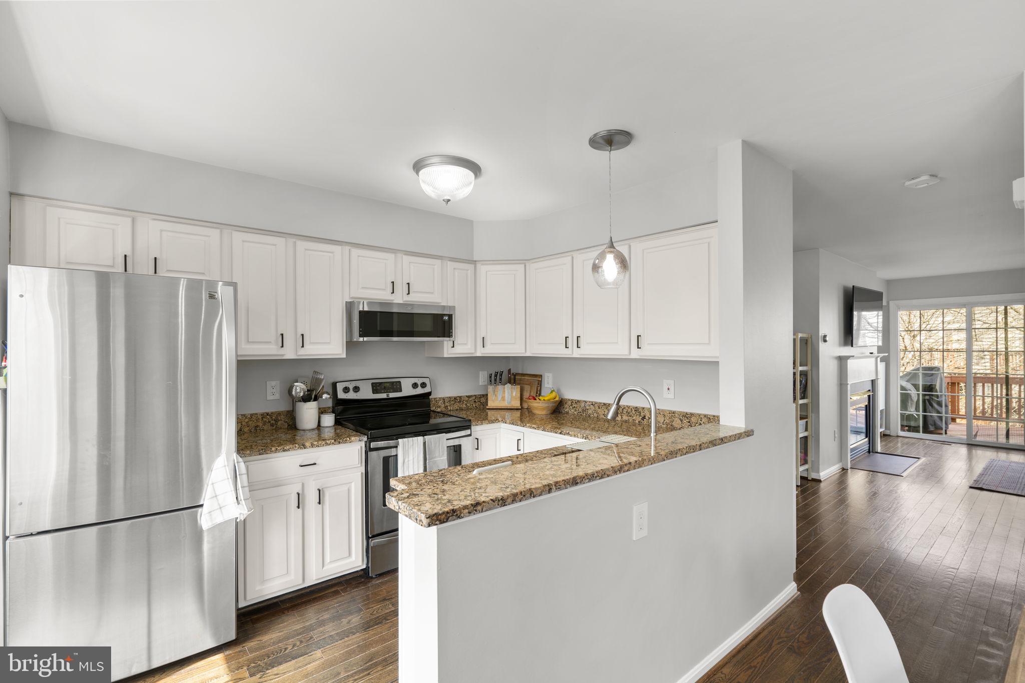 20250 Brookview Square Ashburn, VA 20147 - Photo 16 of 45 a kitchen with stainless steel appliances granite countertop a refrigerator sink and stove