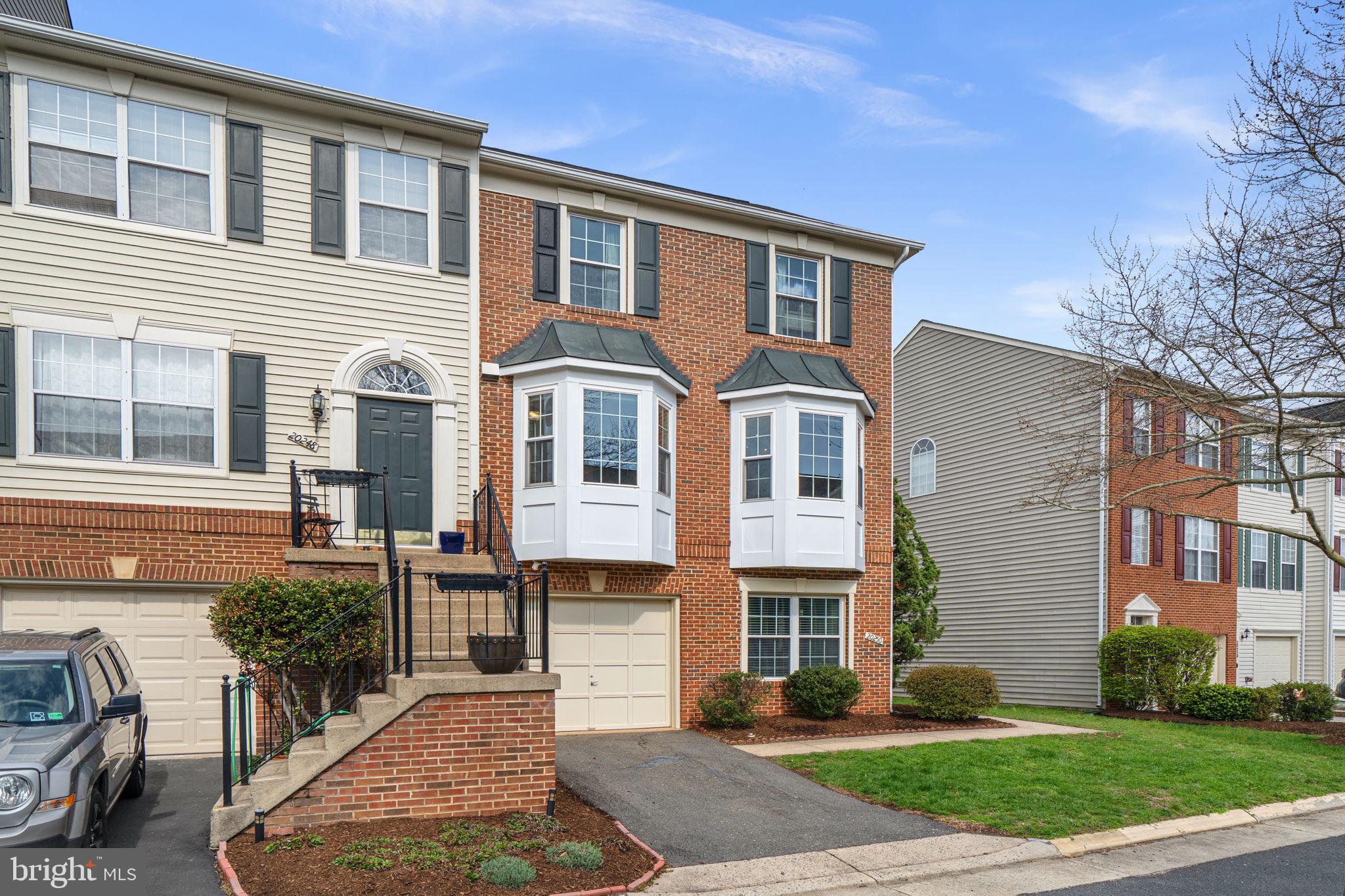 20250 Brookview Square Ashburn, VA 20147 - Photo 2 of 45 a front view of a house with garden
