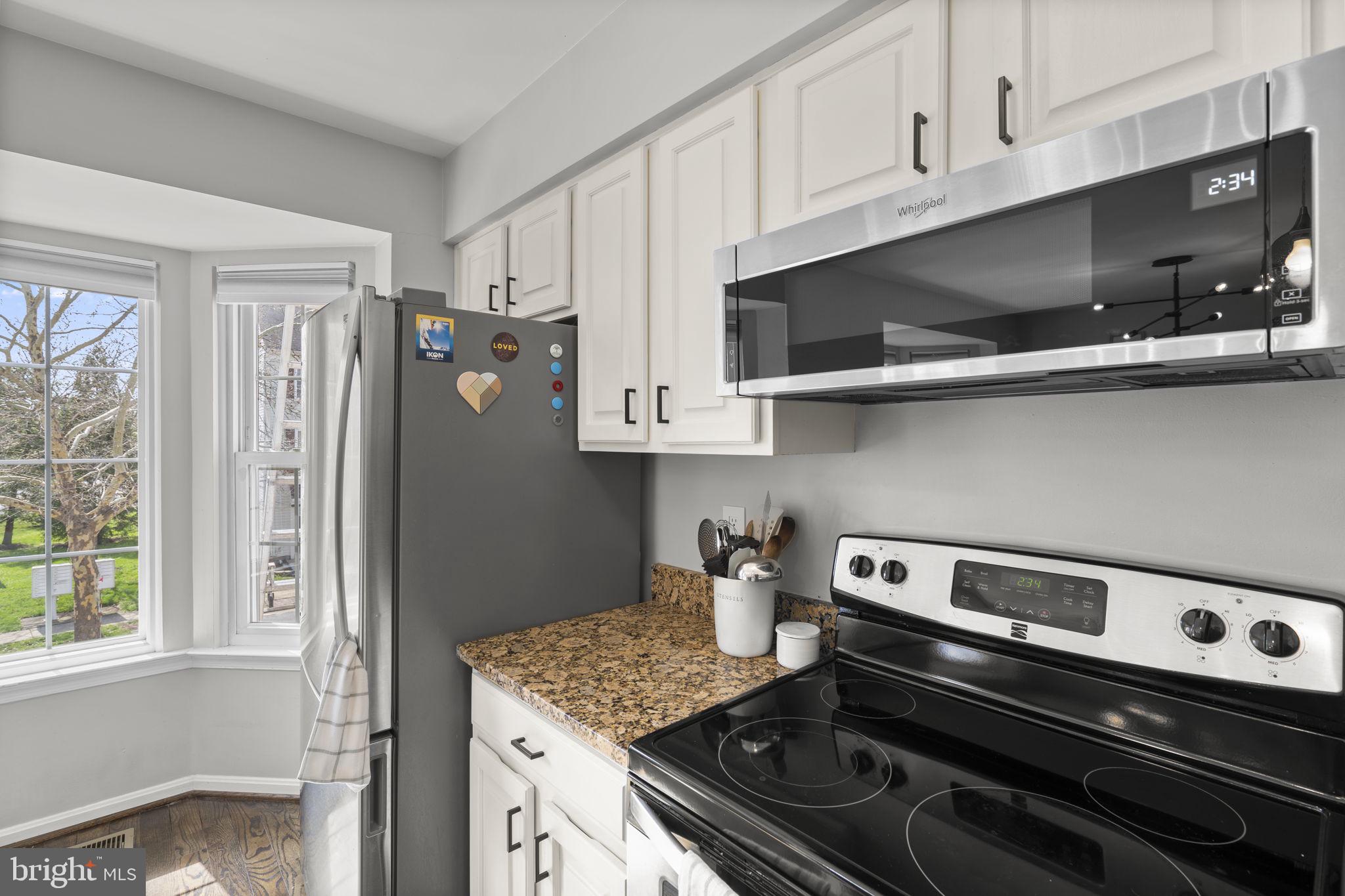 20250 Brookview Square Ashburn, VA 20147 - Photo 21 of 45 a kitchen with stainless steel appliances granite countertop a refrigerator and a stove