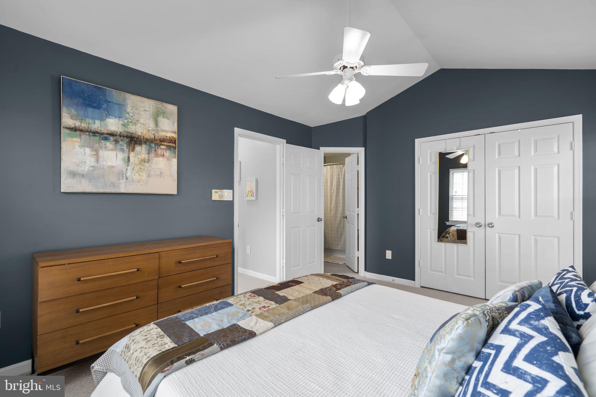 20250 Brookview Square Ashburn, VA 20147 - Photo 26 of 45 a bedroom with a bed and a chandelier
