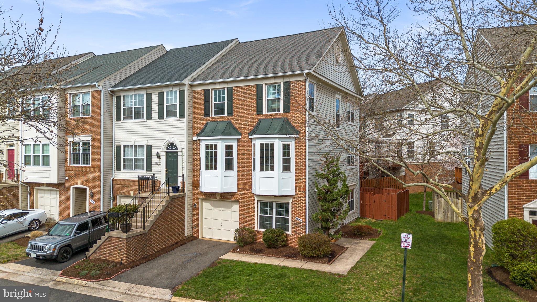 20250 Brookview Square Ashburn, VA 20147 - Photo 45 of 45 a view of a white house next to a yard with big trees