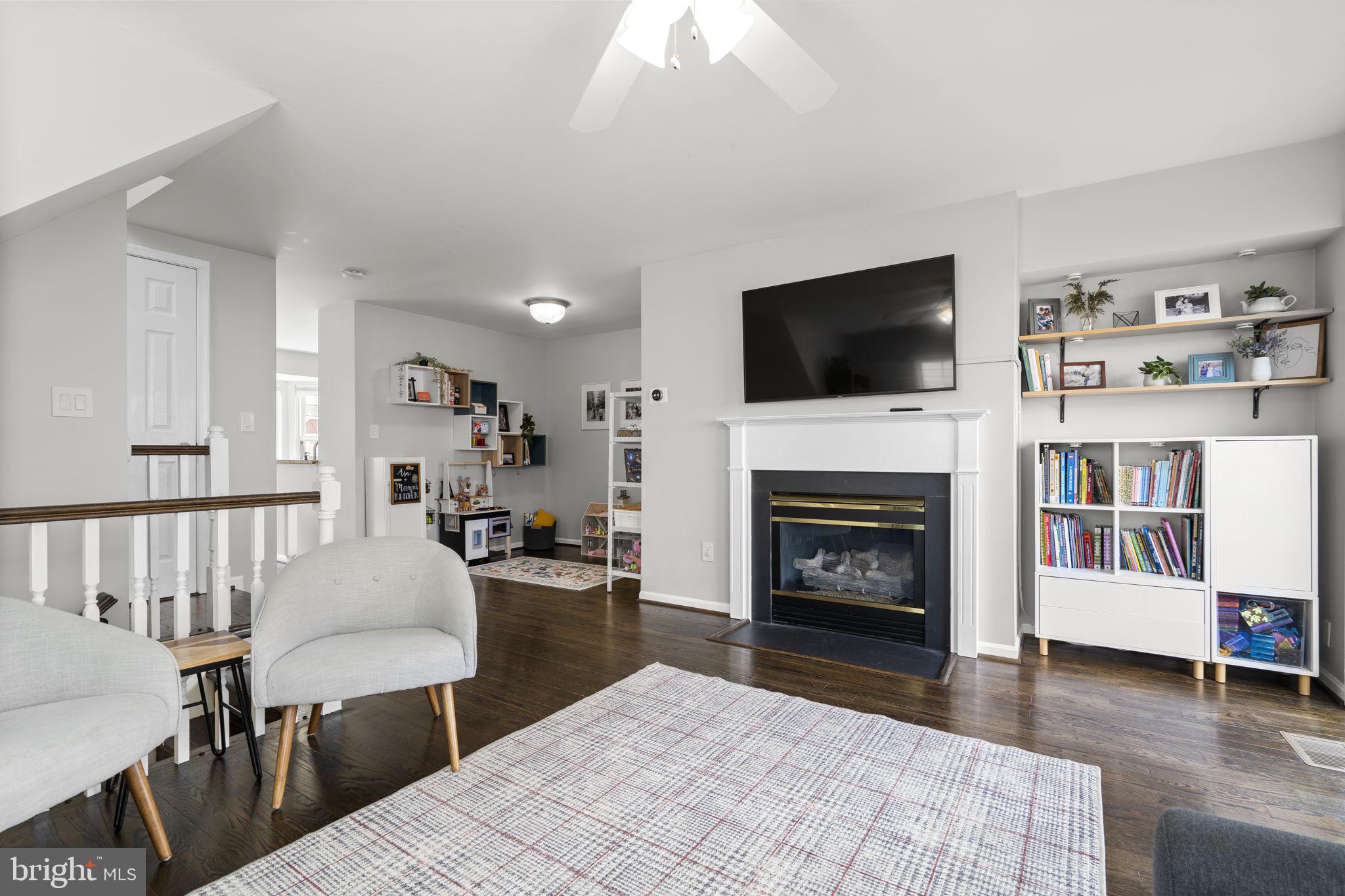 20250 Brookview Square Ashburn, VA 20147 - Photo 6 of 45 a living room with furniture a flat screen tv and a fireplace