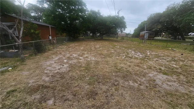a backyard of a house with lots of green space and trees all around