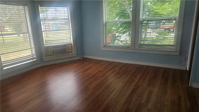 a view of wooden floor and windows in a room