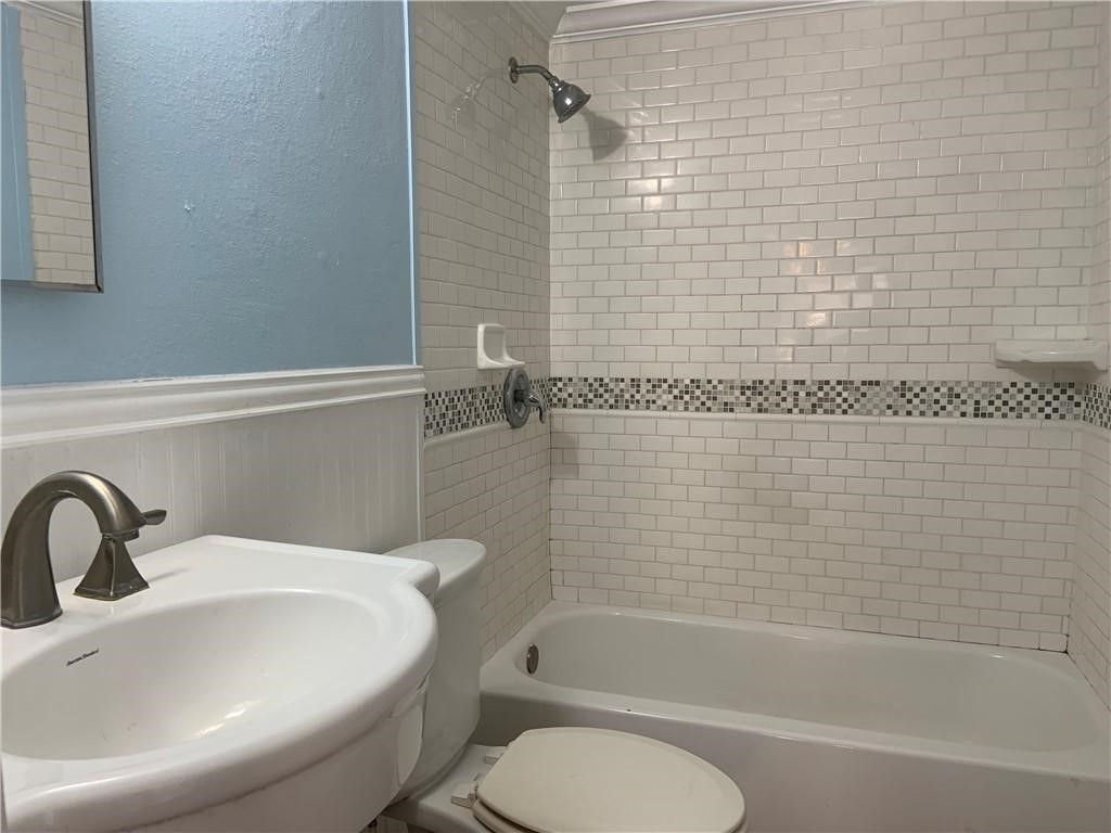 215 North Rife Street Aransas Pass, TX 78336 - Photo 10 of 11 a bathroom with a sink toilet and shower