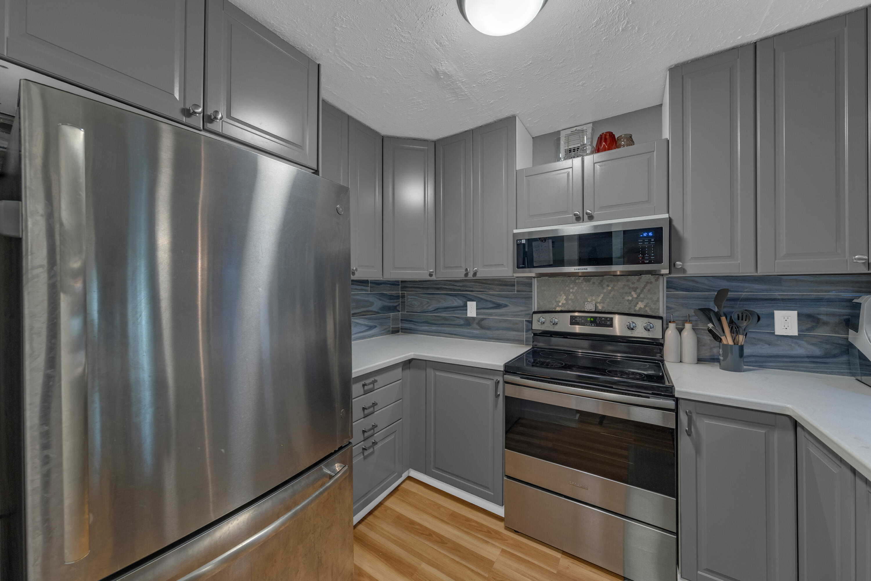 301 North Pine Island Road, Unit 101 Plantation, FL 33324 - Photo 35 of 51 a kitchen with a refrigerator and a stove top oven