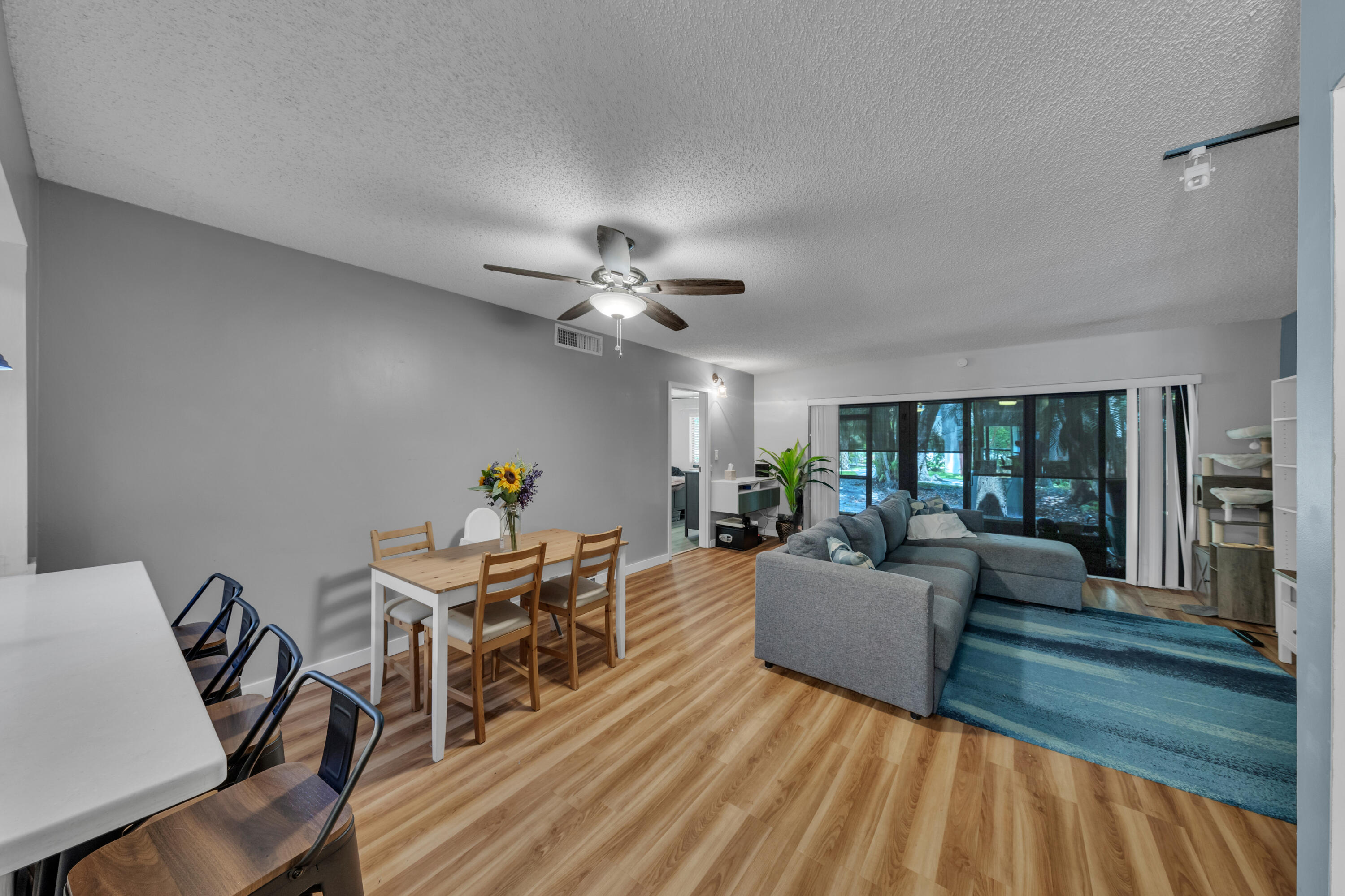 301 North Pine Island Road, Unit 101 Plantation, FL 33324 - Photo 5 of 51 a living room with furniture and a chandelier