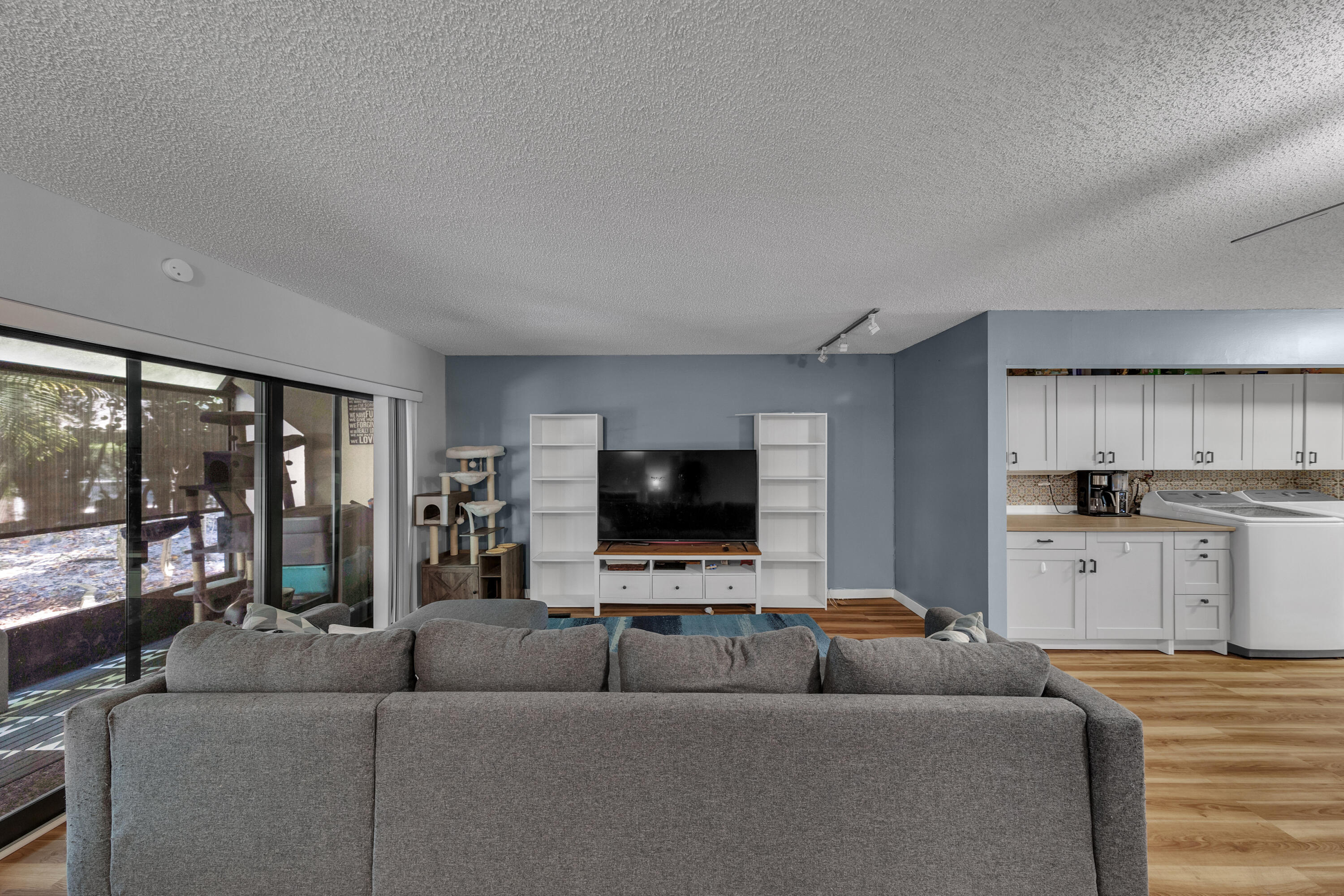 301 North Pine Island Road, Unit 101 Plantation, FL 33324 - Photo 6 of 51 a living room with furniture and a flat screen tv