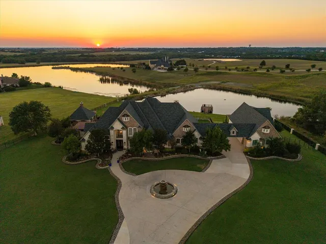 an aerial view of a house with garden space and lake view