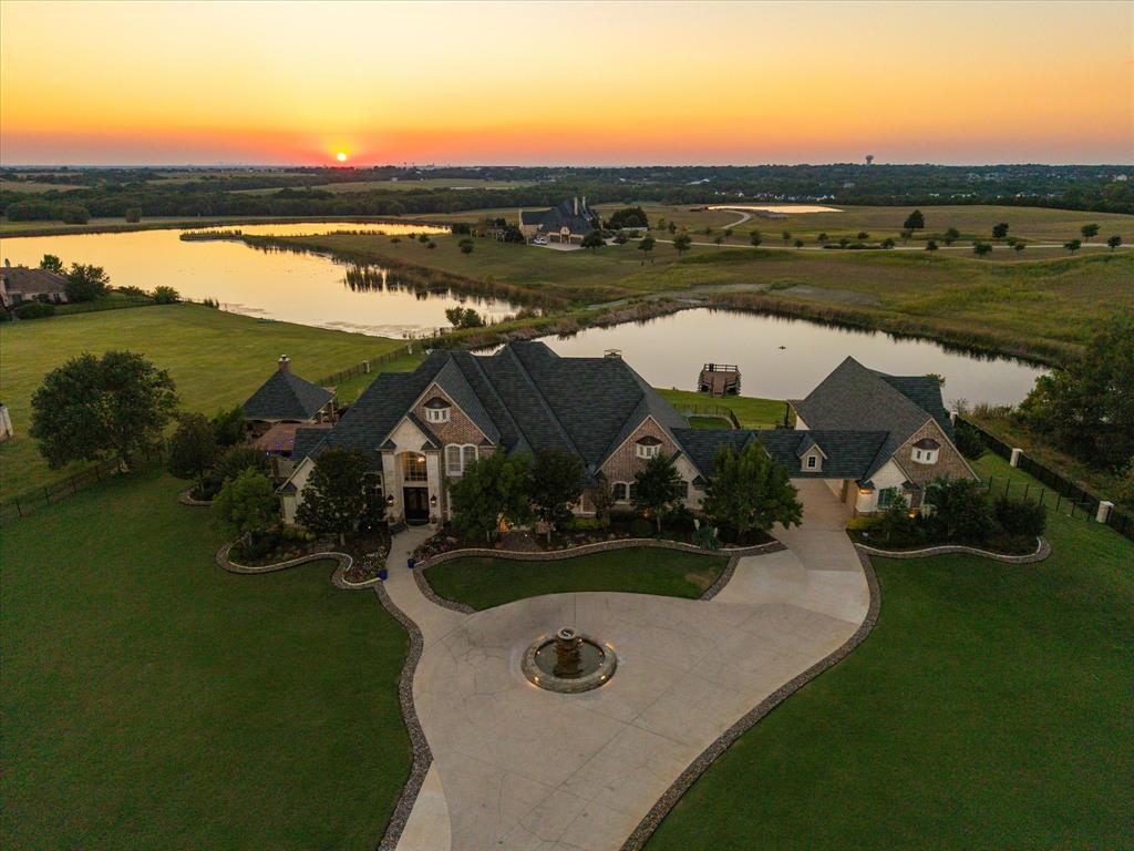 an aerial view of a house with garden space and lake view