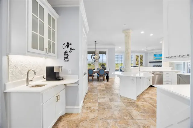 a kitchen with kitchen island white cabinets and white appliances