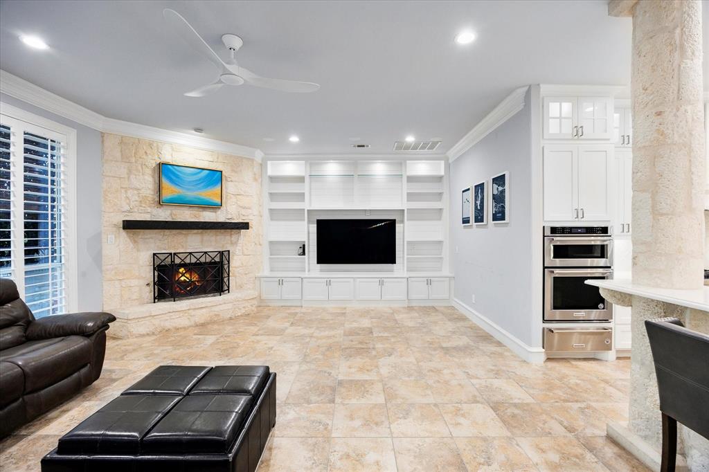 1572 Rabbit Rdg Road Heath, TX 75032 - Photo 18 of 36 a living room with furniture and a fireplace
