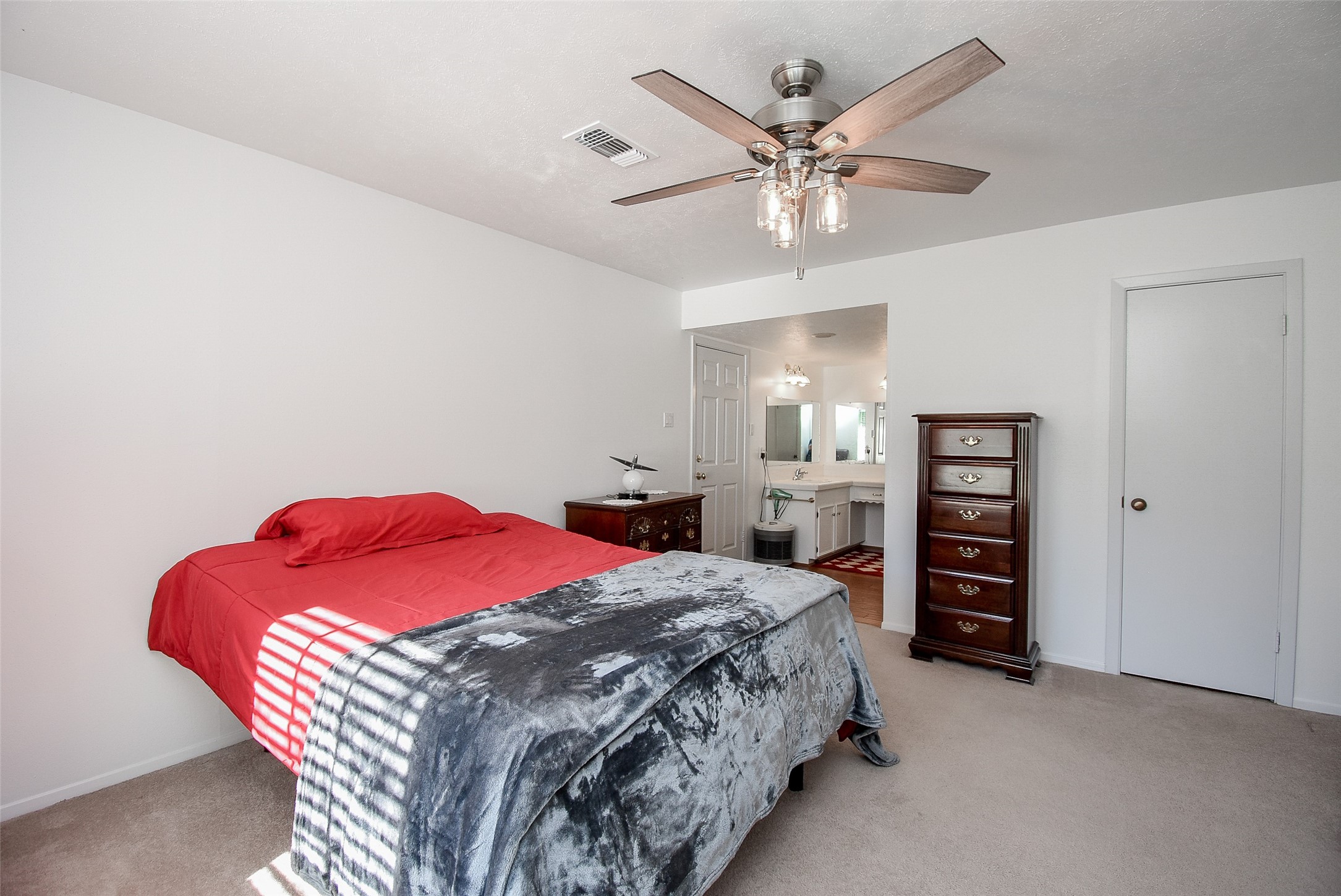 24640 Macedonia Road Hockley, TX 77447 - Photo 18 of 46 a bedroom with a bed and a ceiling fan
