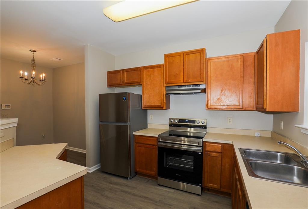 6926 Rogers Point Lithonia, GA 30058 - Photo 12 of 19 a kitchen with a refrigerator stove and sink